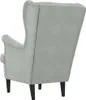 A rear view of a light gray velvet armchair with black legs. Náhľad obrázku produktu