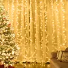 A decorated Christmas tree and a curtain with lights and feathers. Produktbild-Vorschau