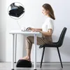 Woman sitting at a desk using a laptop with a footrest. Produktbild-Vorschau