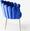 A blue velvet armchair with gold legs is shown against a white background. Produktbild-Vorschau