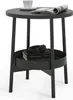 A dark gray side table with a round top and a lower shelf holding books and headphones. Náhled obrázku produktu