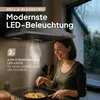 A woman is cooking in a kitchen with a modern range hood above her. Produktbild-Vorschau