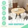 A round wooden dining table with black metal legs, surrounded by chairs in a dining room setting. Produktbild-Vorschau