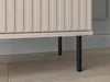 Close-up view of the bottom part of a beige cabinet with vertical ribbed detailing, supported by thin black legs, resting on a tiled floor. Náhľad obrázku produktu