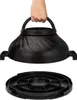 A hand holding the lid of a black kitchen appliance, with the base shown below. Produktbild-Vorschau
