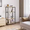 A shelf unit with books and decor items in a room setting with a couch and curtains. Náhľad obrázku produktu