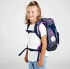 A young girl wearing a backpack against a white background. Náhľad obrázku produktu