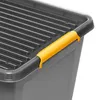 A close-up view of the corner of a gray storage box with a yellow handle. Produktbild-Vorschau