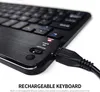 Close-up of a black rechargeable keyboard with a USB cable plugged in. Náhled obrázku produktu