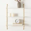 A three-tiered wall shelf with decorative items. Voir les images du produit