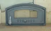 A cast iron oven door with a glass window, resting on a stone hearth. Produktbild-Vorschau
