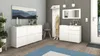 A modern entryway with white furniture, a mirror, and decorative items. Produktbild-Vorschau