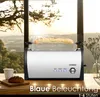 A toaster with bread inside is placed on a table by a large window with a view of a landscape at sunset. Produktbild-Vorschau