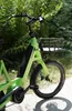 A close-up shot of the front of a green electric bicycle. Produktbild-Vorschau
