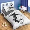 A child's bedroom with a bed featuring soccer-themed bedding, a nightstand with books and headphones, and a backpack. Náhled obrázku produktu