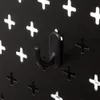 A close-up of a black hook attached to a black pegboard with white cross-shaped cutouts. Podgląd zdjęcia produktu