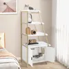 A cat tree with shelves and a hidden litter box compartment is shown in a bedroom setting next to a bed. Produktbild-Vorschau