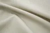 A close-up view of a textured, beige fabric, likely a curtain or textile, with soft folds and shadows. Produktbild-Vorschau