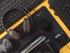 A flat lay of gaming accessories on a yellow and black surface. Anteprima dell’immagine prodotto