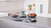 A kitchen counter with a Ninja CRISPi air fryer and two glass containers filled with food. Anteprima dell’immagine prodotto