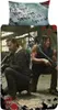 Two men from The Walking Dead are shown in a crouched position, holding weapons, in what appears to be an abandoned building. Produktbild-Vorschau