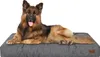 A German Shepherd dog lying on a gray dog bed. Náhled obrázku produktu