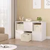 A white storage unit with cream-colored fabric boxes is shown in a living room setting. Produktbild-Vorschau
