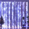 A room decorated with a Christmas tree and curtains adorned with LED lights. Náhled obrázku produktu