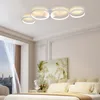 A bedroom scene with a modern ceiling light fixture above a bed. Voir les images du produit
