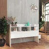 A modern living room with a white console table displaying decorative items, next to a large plant and a floor lamp. Podgląd zdjęcia produktu