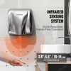 A hand dryer mounted on a tiled wall, with a hand being placed underneath to demonstrate its sensor range. Podgląd zdjęcia produktu