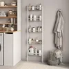 A bathroom or laundry room setting with a tall shelving unit filled with various bottles and containers, a bathrobe hanging on the wall, and a laundry basket filled with towels. Podgląd zdjęcia produktu