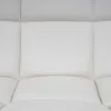A close-up view of a tufted cream-colored material, likely upholstery. Náhled obrázku produktu