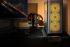 A gaming PC setup on a desk, featuring a monitor, keyboard, mouse, headphones, and a computer tower with illuminated fans. Produktbild-Vorschau