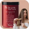 A woman is shown with a large red tub of hair mask and is combing her hair. Anteprima dell’immagine prodotto