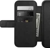 A close-up view of an open black leather iPhone folio case, showing card slots and a dollar bill. Produktbild-Vorschau