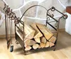 A fireplace log rack with tools next to a stone wall and wooden floor. Podgląd zdjęcia produktu