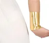 A close-up of a person's arm wearing a gold cuff, with a white garment on the left. Produktbild-Vorschau