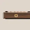 Close-up side view of a wooden mechanical keyboard with a USB-C port. Produktbild-Vorschau