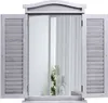 A mirror designed to look like a window with shutters, set against a white background. Náhled obrázku produktu
