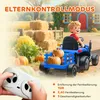 A child is riding a blue toy tractor in a farm-like setting with hay bales and pumpkins. A remote control is in the foreground. Produktbild-Vorschau