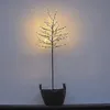 A decorative LED tree with warm white lights in a black pot, set against a light gray wall. Produktbild-Vorschau