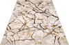 A close-up, angled view of a rug with a marble-like pattern. Voir les images du produit