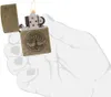 A hand holding a lit Zippo lighter with a tree of life design. Náhľad obrázku produktu