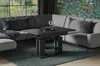 A modern living room with a sectional sofa, coffee table, and a floral wallpaper. Voir les images du produit
