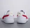 The back view of two white Puma sneakers with red accents and gold logos. Produktbild-Vorschau