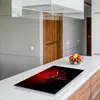 A kitchen counter with a glass stovetop protector featuring a chili pepper design. Náhled obrázku produktu