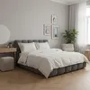 A bedroom scene with a bed, dresser, and chair. Produktbild-Vorschau
