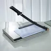 A paper cutter on a desk with a white background and sheer curtains. Produktbild-Vorschau