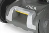 A close-up view of a lawnmower's handle and wheel. Produktbild-Vorschau